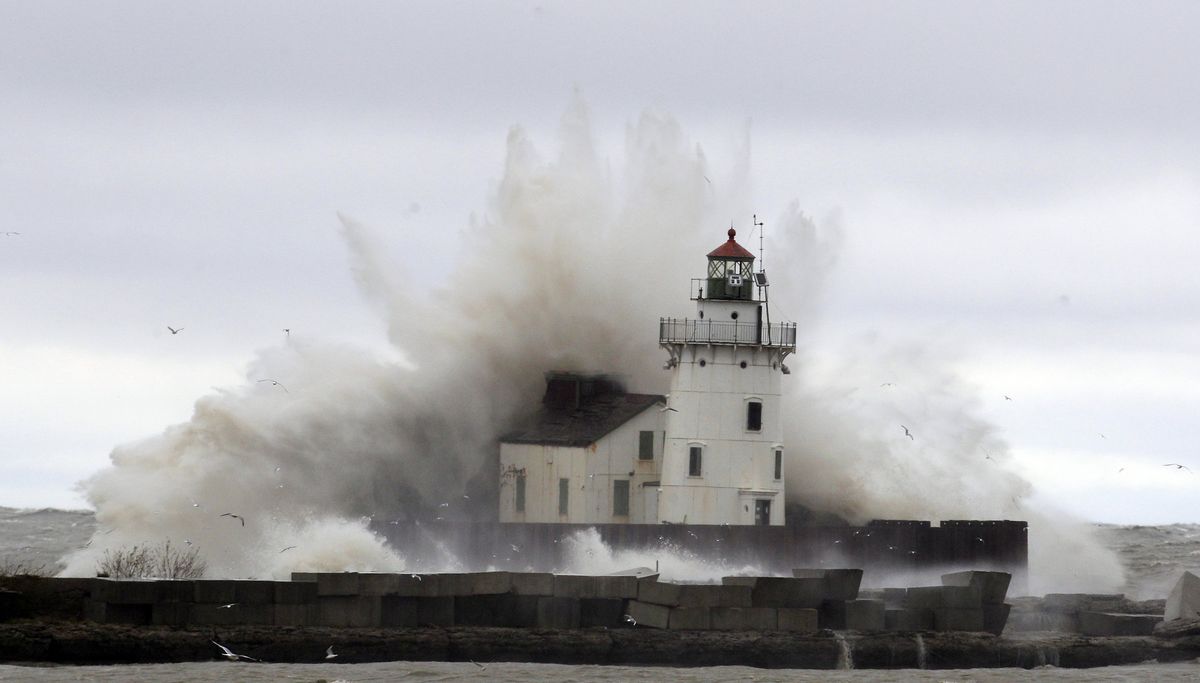 Waves pound a lighthouse on the shores of Lake Erie Tuesday, Oct. 30, 2012, near Cleveland. High winds spinning off the edge of superstorm Sandy took a vicious swipe at northeast Ohio early Tuesday, uprooting trees, cutting power to hundreds of thousands, closing schools and flooding parts of major commuter arteries that run along Lake Erie. (Tony Dejak / Associated Press)