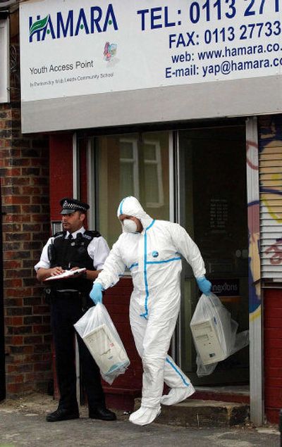 
A forensic police officer carries computer equipment out of a building in Leeds, England, on Friday.
 (Associated Press / The Spokesman-Review)