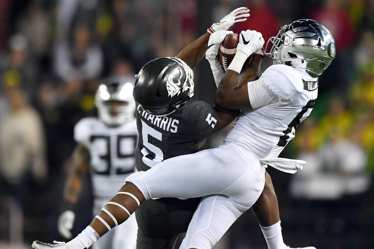 Washington State Cougars slot Travell Harris (5) battles Oregon Ducks safety Jevon Holland (8) for control of a pass for a critical first down during the second half of a Pac-12 game on October 20, 2018, at Martin Stadium in Pullman.  (Tyler Tjomsland/The Spokesman-Review)