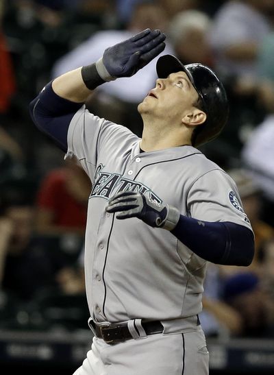 Seattle’s Logan Morrison salutes the sky after his three-run home run in ninth inning. (Associated Press)