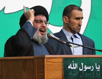 Hezbollah leader Sheik Hassan Nasrallah, left, speaks to a crowd of supporters estimated at 500,000 during a rally in Beirut on Monday denouncing an anti-Islam film that has provoked a week of unrest in Muslim countries worldwide. (Associated Press)