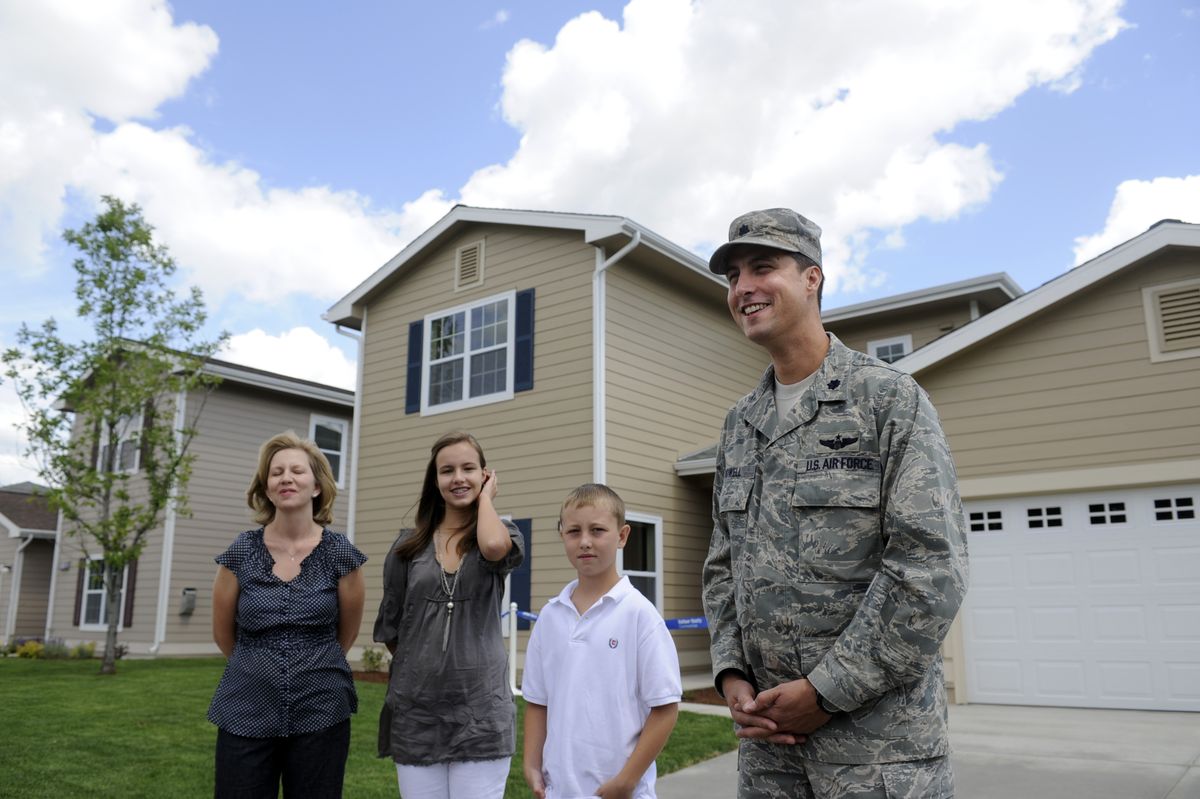 Lt. Col. Bill Rowell and his family, from left, Tanya, Hannah, 14, and Liam, 12, stand in front of a row of new homes, one of which the family will occupy  at Fairchild. (Jesse Tinsley / The Spokesman-Review)