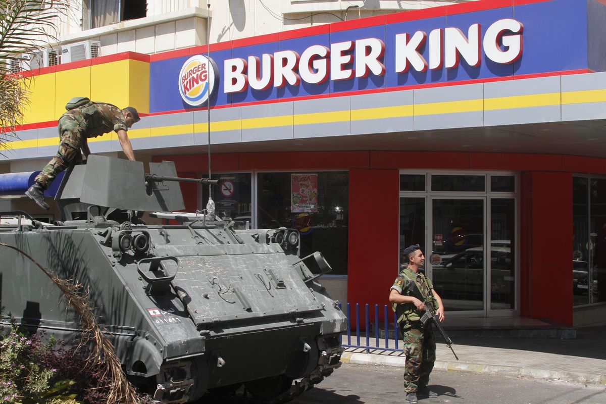Lebanese army soldiers with their armored personnel carrier, stand guard outside a Burger King as part of stepped up security measures in the southern port city of Sidon, Lebanon, Saturday Sept. 15, 2012. Angry protesters attacked on Friday a Hardees and Kentucky Fried Chicken outlets in Tripoli north Lebanon to protest against a movie that insults Prophet Muhammad. (Mohammad Zaatari / Associated Press)
