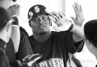 
Seattle's Michael Wilson accepts congratulations after his mammoth home run during Tuesday's intrasquad game. 
 (Associated Press / The Spokesman-Review)