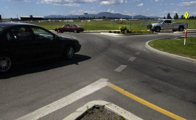 
Cars circle the roundabout at  Fourth Street and Kathleen Avenue in Coeur d'Alene on Monday. 
 (Kathy Plonka / The Spokesman-Review)