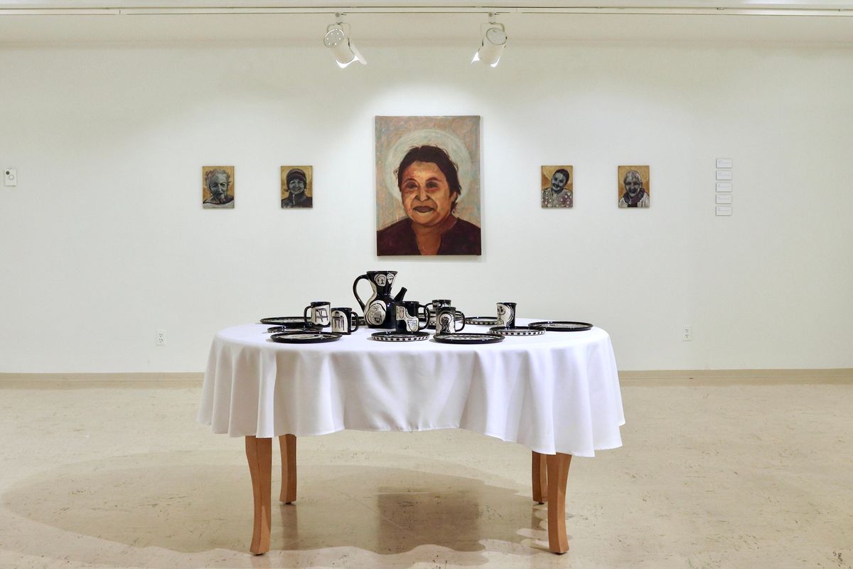 Liv Hebert Watkins’ “The Table is Set” is on display through May at Terrain Gallery. No two ceramic plates on the table are the same.  (Courtesy)