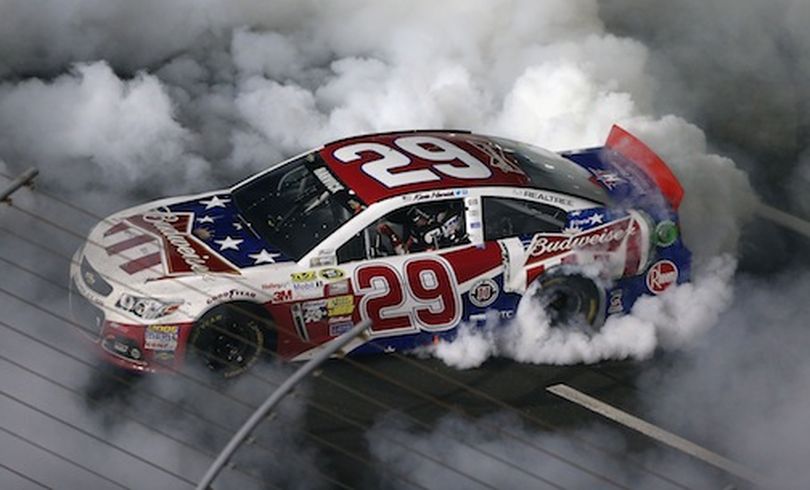 Kevin Harvick, driver of the #29 Budweiser Folds of Honor Chevrolet, celebrates with a burnout after winning the NASCAR Sprint Cup Series Coca-Cola 600 at Charlotte Motor Speedway on May 26, 2013 in Concord, North Carolina. (Photo by Streeter Lecka/Getty Images) (Streeter Lecka / Getty Images North America)