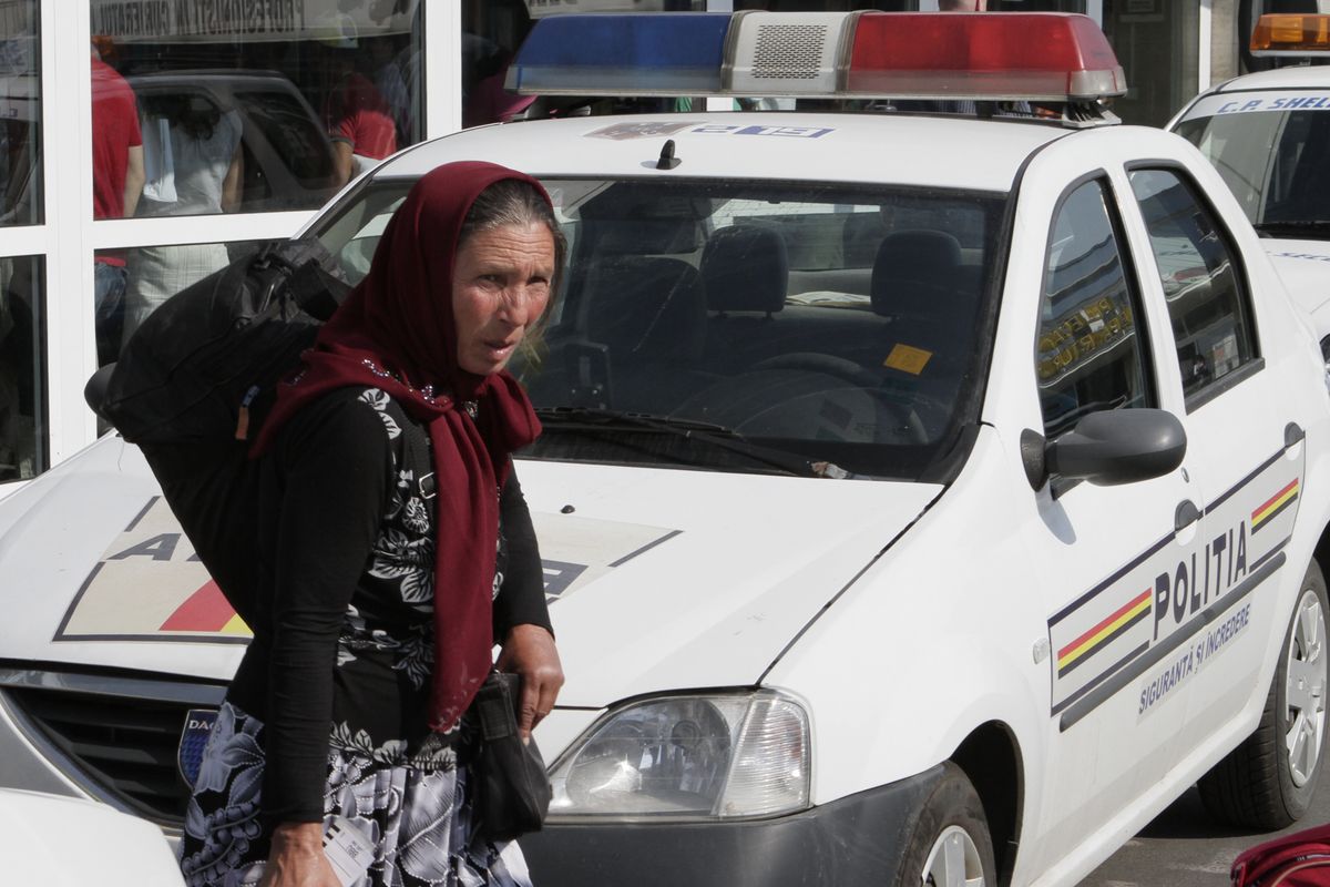 A Romanian Roma woman carries a bag after arriving from France in Bucharest, Romania, Thursday.  (Associated Press)