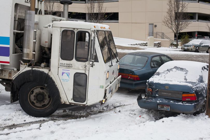 The chains and parking brake of a Spokane garbage truck snapped during the Thursday morning commute. The truck collided with multiple cars on its way down Howard Street near Sixth Avenue.  (Nicole Hensley)