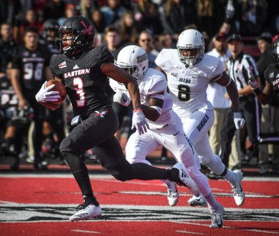 Eastern Washington  quarterback Eric Barriere  races for a long touchdown run against Idaho defenders Tevin Duke and Tre Walker (8)  on Oct. 27 in Cheney. (Dan Pelle / The Spokesman-Review)