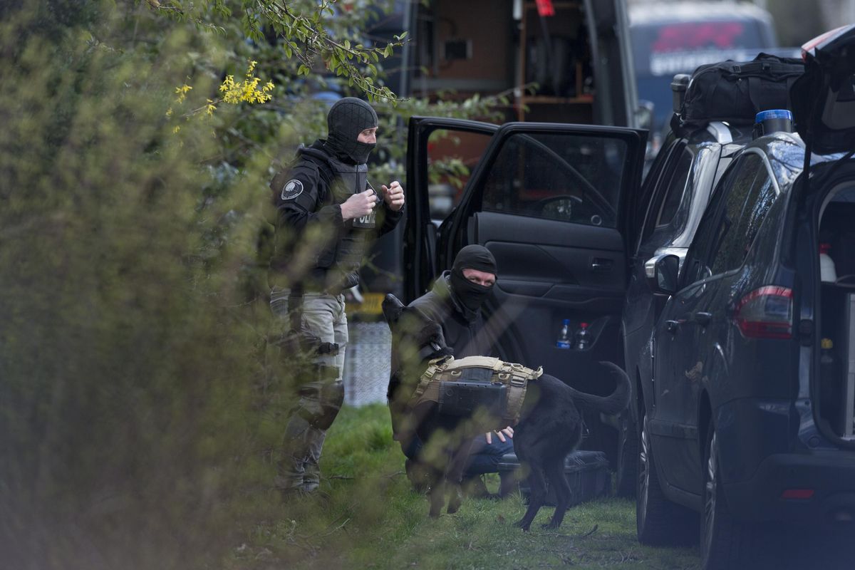Dutch counter terrorism police prepare to enter a house with a sniffer dog equipped with a camera after a shooting incident in Utrecht, Netherlands, Monday, March 18, 2019. A gunman killed three people and wounded nine others on a tram in the central Dutch city of Utrecht, sparking a manhunt that saw heavily armed officers with sniffer dogs zero in on an apartment building close to the shooting. (Peter Dejong / AP)