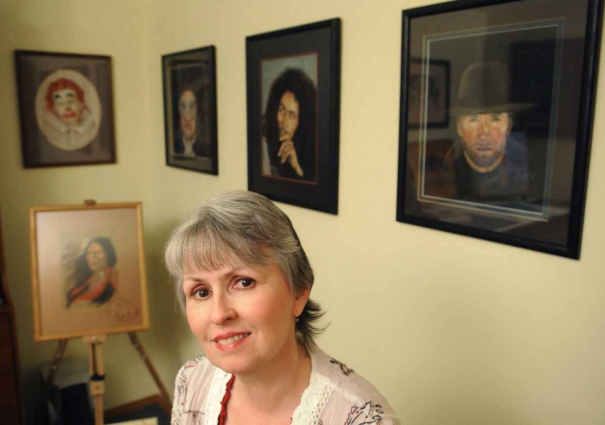 Kat Morris, a writer, painter and quilt designer, is shown in front of a few of her paintings in her home. (Photos by Dan Pelle / The Spokesman-Review)