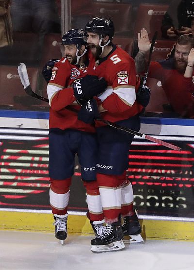 Florida Panthers center Vincent Trocheck, left, Florida Panthers defenseman Aaron Ekblad celebrate a Trocheck scoring a point during the third period of an NHL hockey game against the San Jose Sharks, Monday, Jan. 21, 2019, in Sunrise, Fla. (Brynn Anderson / Associated Press)