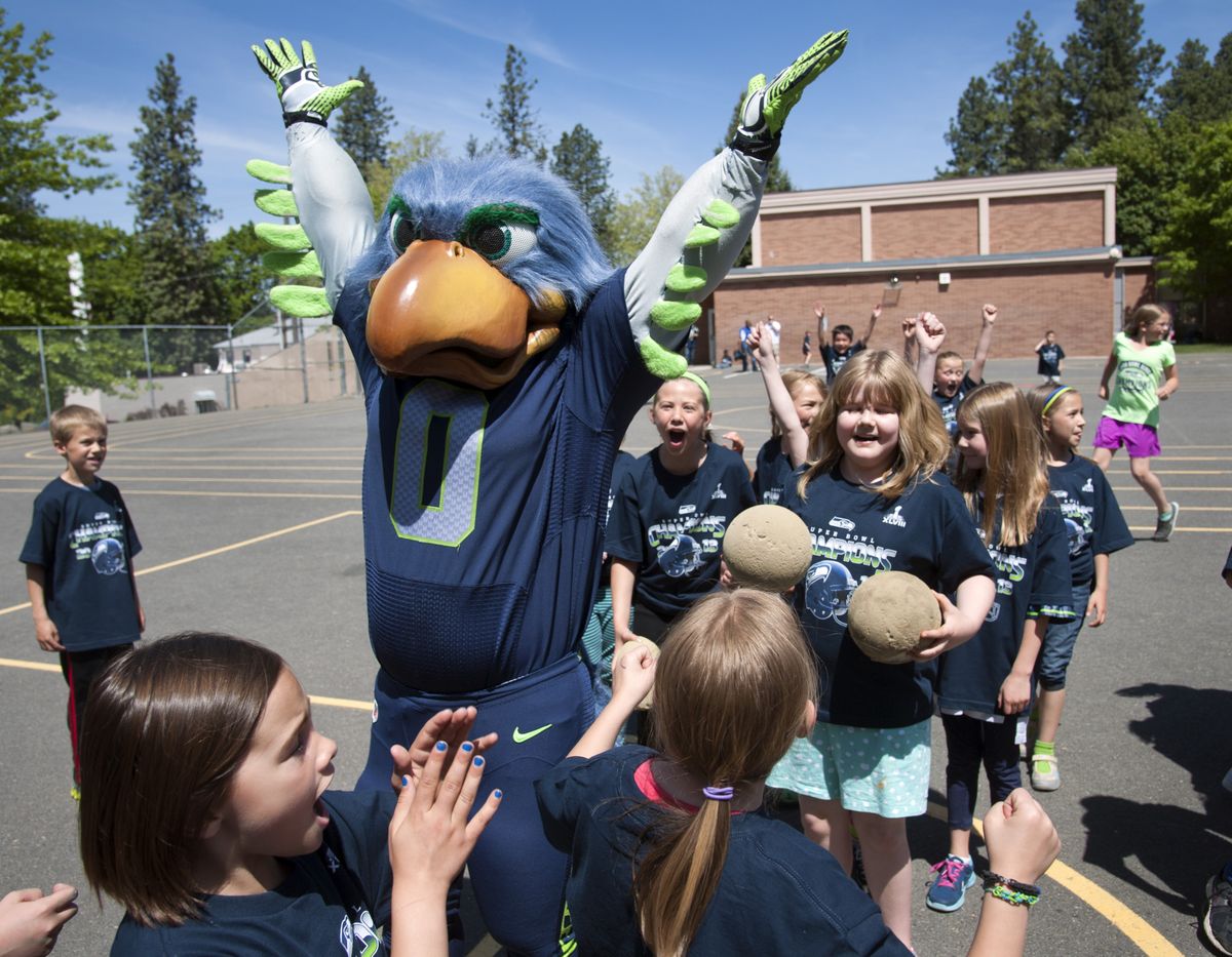 Seahawks mascot Blitz celebrates with students at “Russell” Wilson Elementary after sinking a 3/4 -court shot at recess Thursday. (Dan Pelle)
