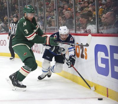 Minnesota Wild center Charlie Coyle (3) defends against Winnipeg Jets defenseman Josh Morrissey (44) in the first period of Game 3 of an NHL first-round hockey playoff series, Sunday, April 15, 2018, in St. Paul, Minn.. The Wild won the game 6-2 but trail the Jets 2-1 in the series. (Andy Clayton-King / Associated Press)