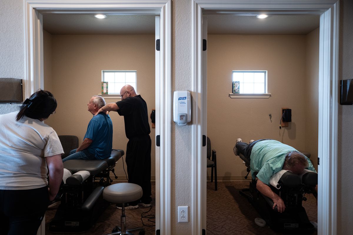 Kiley Timmons with patients at his chiropractic clinic on May 23 in Brownfield, Texas. (ERIN SCHAFF)