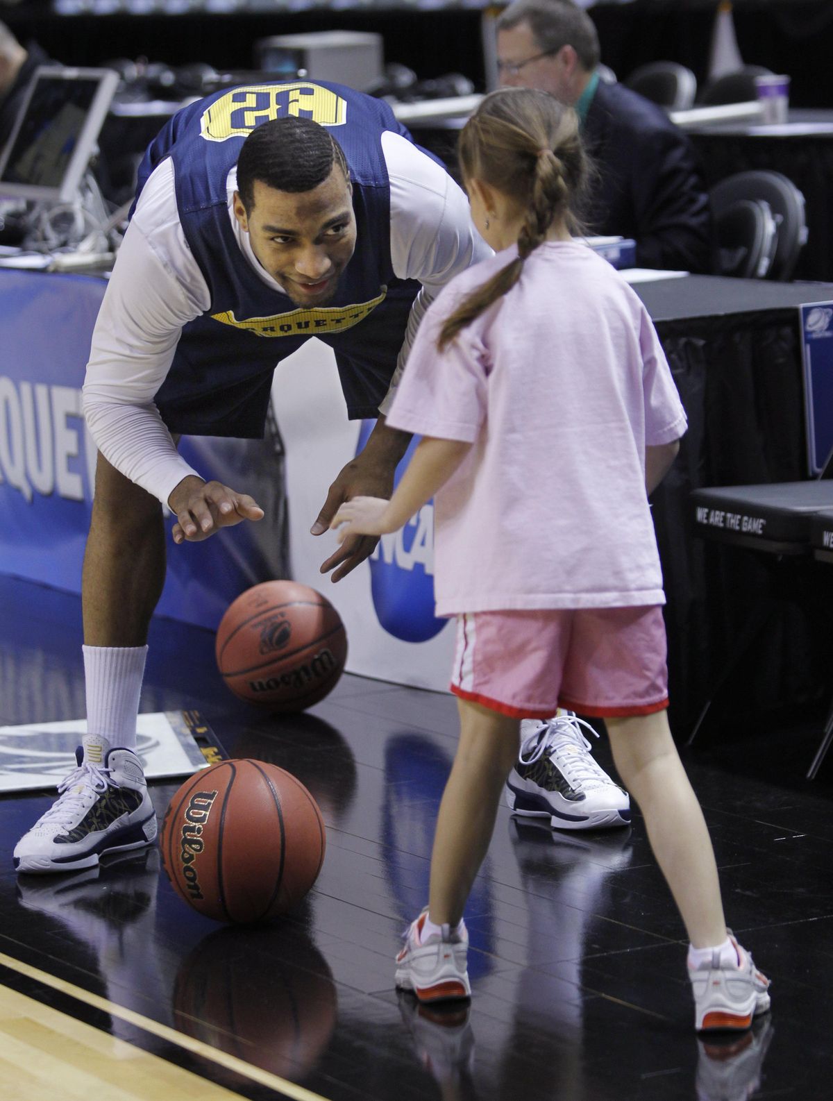 Associated Press Lazar Hayward plays with Zera Williams, the daughter of Marquette head coach Buzz Williams. (Associated Press)