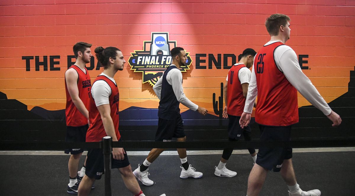 Gonzaga players, including from left, Jack Beach, Rem Bakamus, Nigel Williams-Goss, Bryan Alberts and Ryan Edwards, walk past The Road Ends Here sign on their way to the locker room after Friday’s practice. (Dan Pelle / The Spokesman-Review)