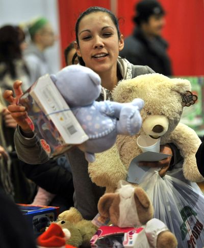 Stephanie Marl, 30, of Spokane, had a hard time deciding which teddy bears to choose for her four children. Marl made her way through the Christmas Bureau’s toy room on Tuesday, the final day of operation at the Spokane County Fair and Expo Center. (Dan Pelle)