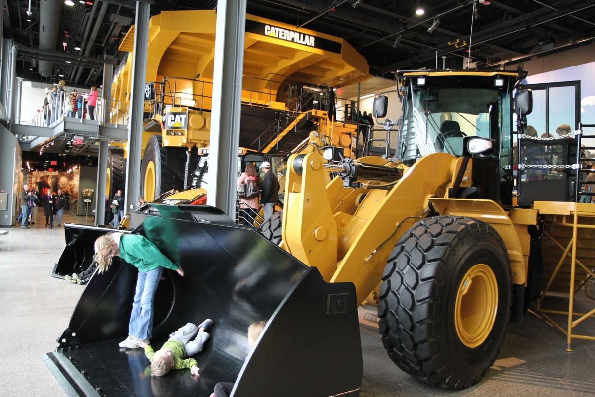 Children climb on equipment on display at the Caterpillar Visitors Center in Peoria, Ill. (Associated Press)
