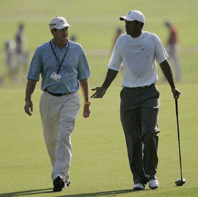 
Tiger Woods, walking with coach Hank Haney during a practice round for the U.S. Open, bemoans the dearth of African-Americans on the PGA Tour.
 (Associated Press / The Spokesman-Review)