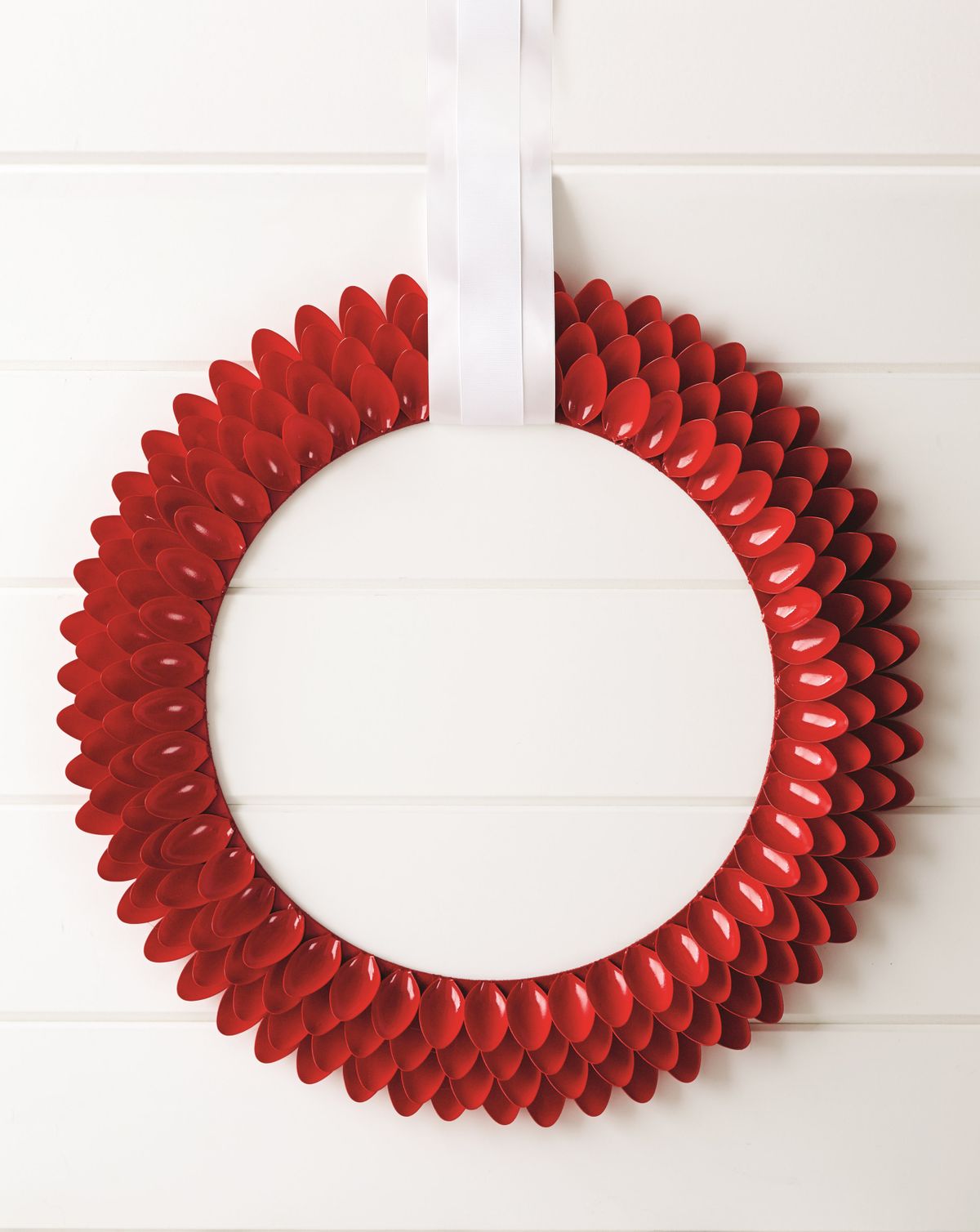 Style at Home designer Stephanie Hung creates contemporary wreaths out of unexpected materials, such as spoons, above, paper straws, below, and other materials like paper cups, paint chips and clothespins. (Associated Press)