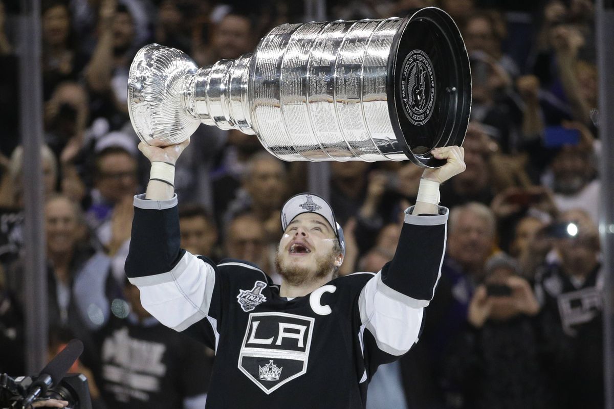 Kings captain Dustin Brown raises the Stanley Cup after Los Angeles beat the Rangers in two overtimes in Game 5 of the Stanley Cup Final. (Associated Press)