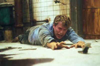 
Dr. Lawrence Gordon, played by Cary Elwes, finds himself chained to a rusty pipe inside a decrepit subterranean chamber in  