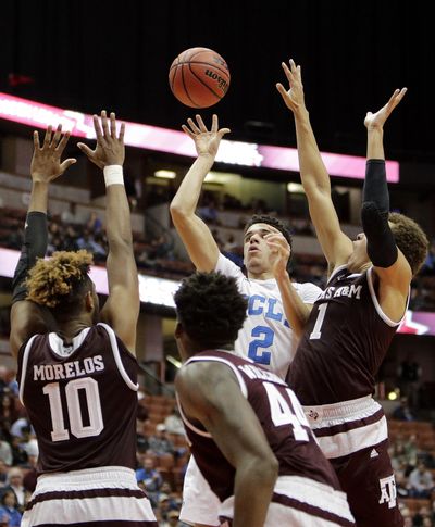 UCLA's Lonzo Ball, top center, shoots over, from left to right, Texas A&M's Tonny Trocha-Morelos, Robert Williams and DJ Hogg during the second half in game Sunday. (Jae C. Hong / Associated Press)