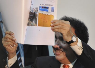 Rehman Malik of Pakistan’s Interior Ministry shows evidence about the Mumbai terrorist attacks to the media during a news conference Thursday.  (Associated Press / The Spokesman-Review)