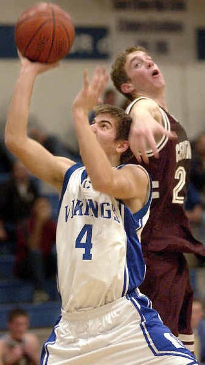 
Coeur d'Alene's Jake Wolfe, left, drives to the basket and is fouled by Centennial's Craig McGee. 
 (Tom Davenport/ / The Spokesman-Review)