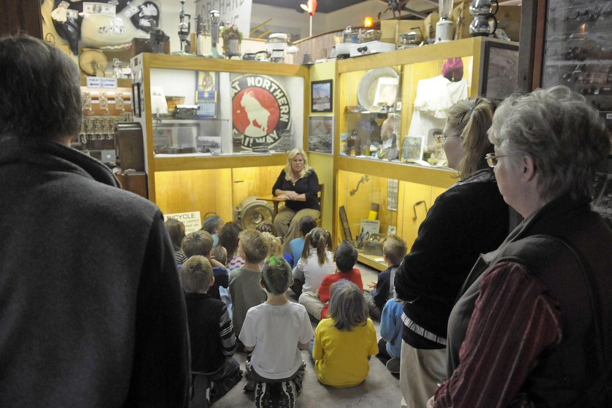 Jayne Singleton, director of the Spokane Valley Heritage Museum, greets students during their visit  Oct. 22. During field trips, schoolchildren  experience the Valley’s past in exhibits like “Under One Sky” that  highlight events in Spokane Valley from 1800 to 1899. (Christopher Anderson)
