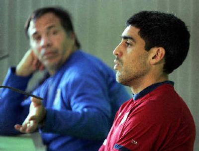 
Coach Bruce Arena, left, passes along a news conference question to U.S. captain Claudio Reyna. 
 (Associated Press / The Spokesman-Review)