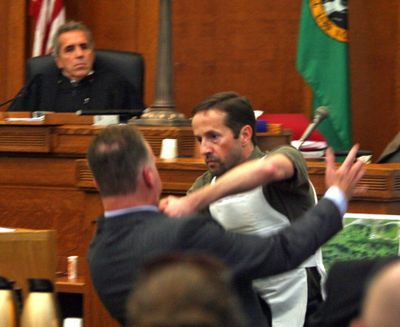 Michiel Oakes demonstrates in front of the jury how he fought with T. Mark Stover at the Skagit County Superior Court, in Mount Vernon, Wash., Tuesday, Oct. 12, 2010. Oakes, who claims self-defense in Stover's killing, wears a bulletproof vest similar to the one he wore during his confrontation with Stover last year. (Greg Gilbert / The Seattle Times)
