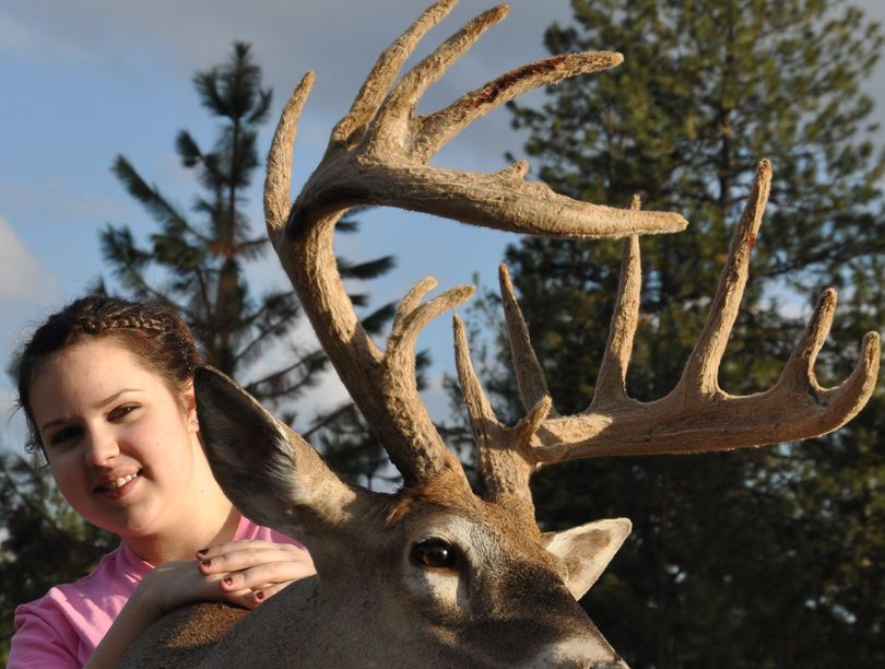 LaFawn Sutton poses with the whitetail buck in velvet she killed during the archery season on her family’s property north of Spokane in September. (Rich Landers)