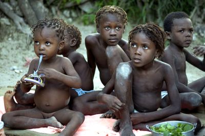Malnourished children sit outside their homes in Deschapelles, Haiti, in June. Funding delays, a dysfunctional central government and transportation problems are  delaying aid.  (Associated Press / The Spokesman-Review)