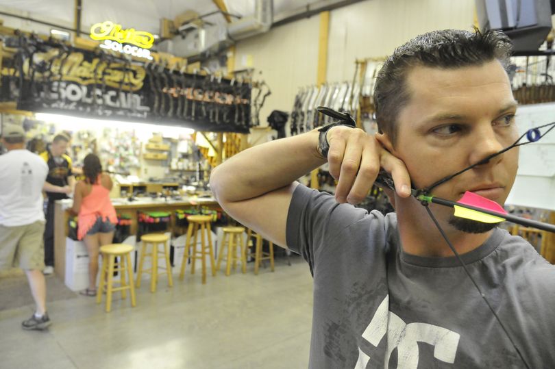 Avid archer and hunter Jake Hodge holds the tension on his bow and checks the sights after they were adjusted at Spokane Valley Archery Friday. The large shop, with a small indoor range and large outdoor range, is a destination for archers looking for technical experience in the shop and a place to shoot, alone or in a league. (Jesse Tinsley)