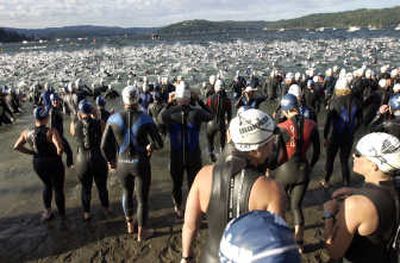 
Lake Coeur d'Alene's rough water conditions are visible from the back of the pack Sunday at the start of the fifth Ford Ironman Coeur d'Alene.
 (Photos by J. Bart Rayniak / The Spokesman-Review)