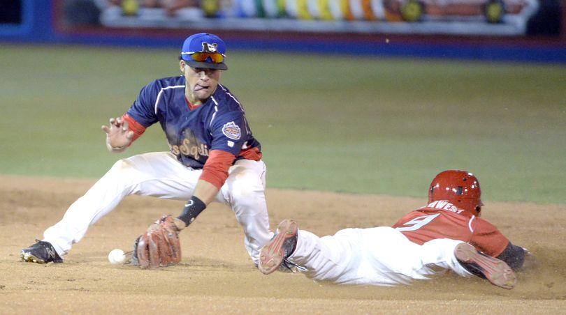 Spokane's LeDarious Clark, representing the Northwest League, slides safely into second as Isan Diaz of the Missoula Osprey can't keep hold of the ball during the All-Star Game Tuesday, Aug. 4, 2015 at Avista Stadium. (Jesse Tinsley / The Spokesman-Review)