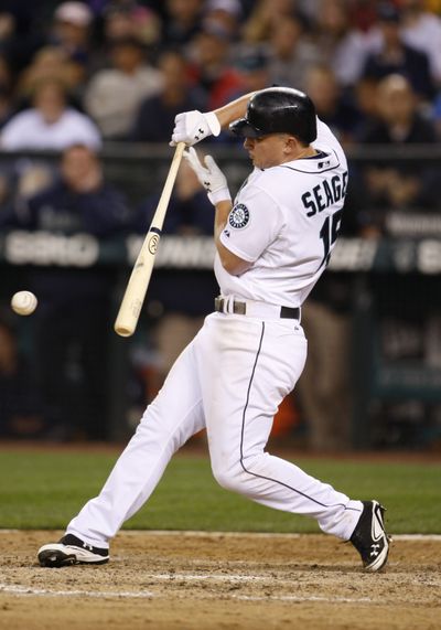 Kyle Seager hits a dribbler in the eighth for an RBI. (Associated Press)