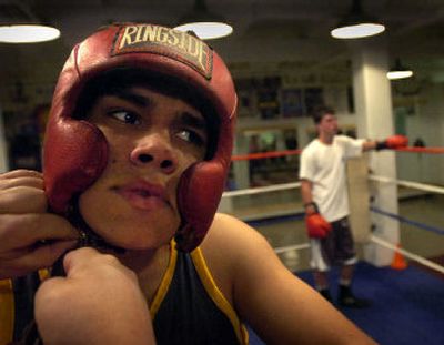 
Kevin Keefe, 20, owner of the Howard Street Boxing Club gets help taking off his head protection by his manager, Dan Vassar. 
 (Jed Conklin / The Spokesman-Review)