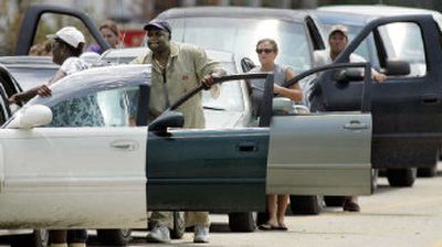 
Motorists push their cars in a long line as they wait to fill their vehicles with gasoline off of Highway 63 in Pascagoula, Miss., on Thursday. 
 (Associated Press / The Spokesman-Review)