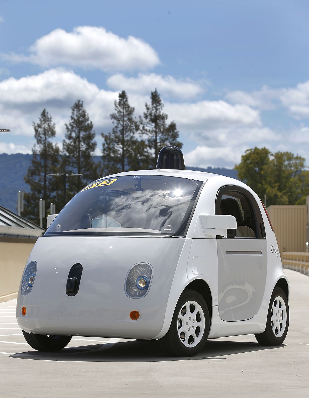 Google’s new self-driving prototype car drives around a parking lot during a demonstration at Google campus in Mountain View, Calif. The car, which needs no gas pedal or steering wheel, will make its debut on public roads this summer. (Associated Press)