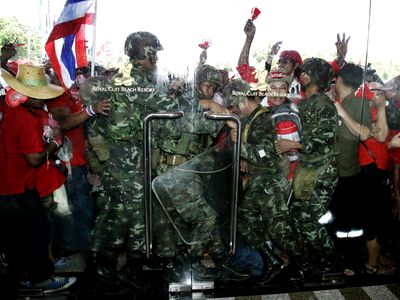 Anti-government demonstrators storm past Thai soldiers  Saturday at the ASEAN Summit convention hall in Pattaya, Thailand.  (Associated Press / The Spokesman-Review)