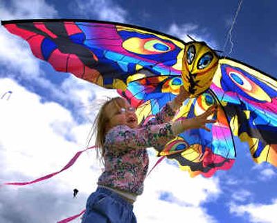 
With her mom, Jennifer Cubley, at the other end of the line, Kelly-anne Cubley, 7, helps launch their kite Sunday at the South Side Soccer Complex. 
 (Colin Mulvany / The Spokesman-Review)