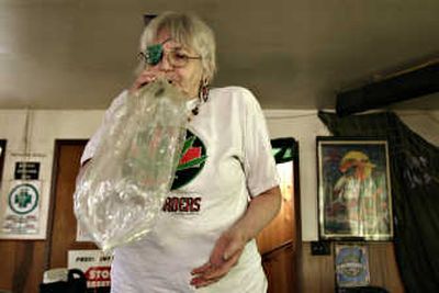 
Joanna McKee uses a vaporizer to get a dose of medical marijuana on Wednesday in Seattle. Associated Press
 (Associated Press / The Spokesman-Review)