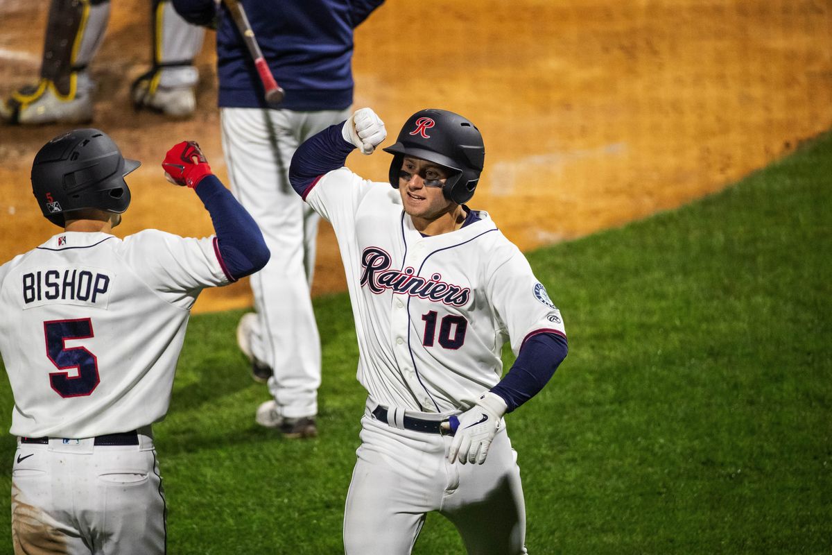 Tacoma Rainiers outfielder Jarred Kelenic bumps arms with Braden Bishop after Kelenic’s second home run of the night on Thursday during a Triple-A game in Tacoma.  (Dean Rutz/Seattle Times)