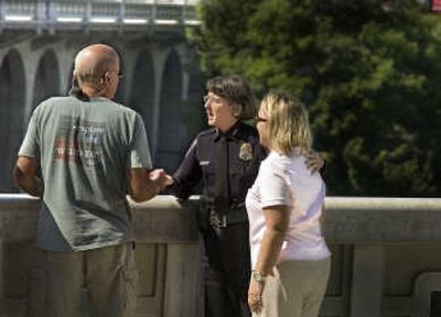 Spokane Police Chief Anne Kirkpatrick speaks with family members Friday at a sidewalk railing overlooking the Monroe Street Bridge.
(CHRISTOPHER ANDERSON / The Spokesman-Review)