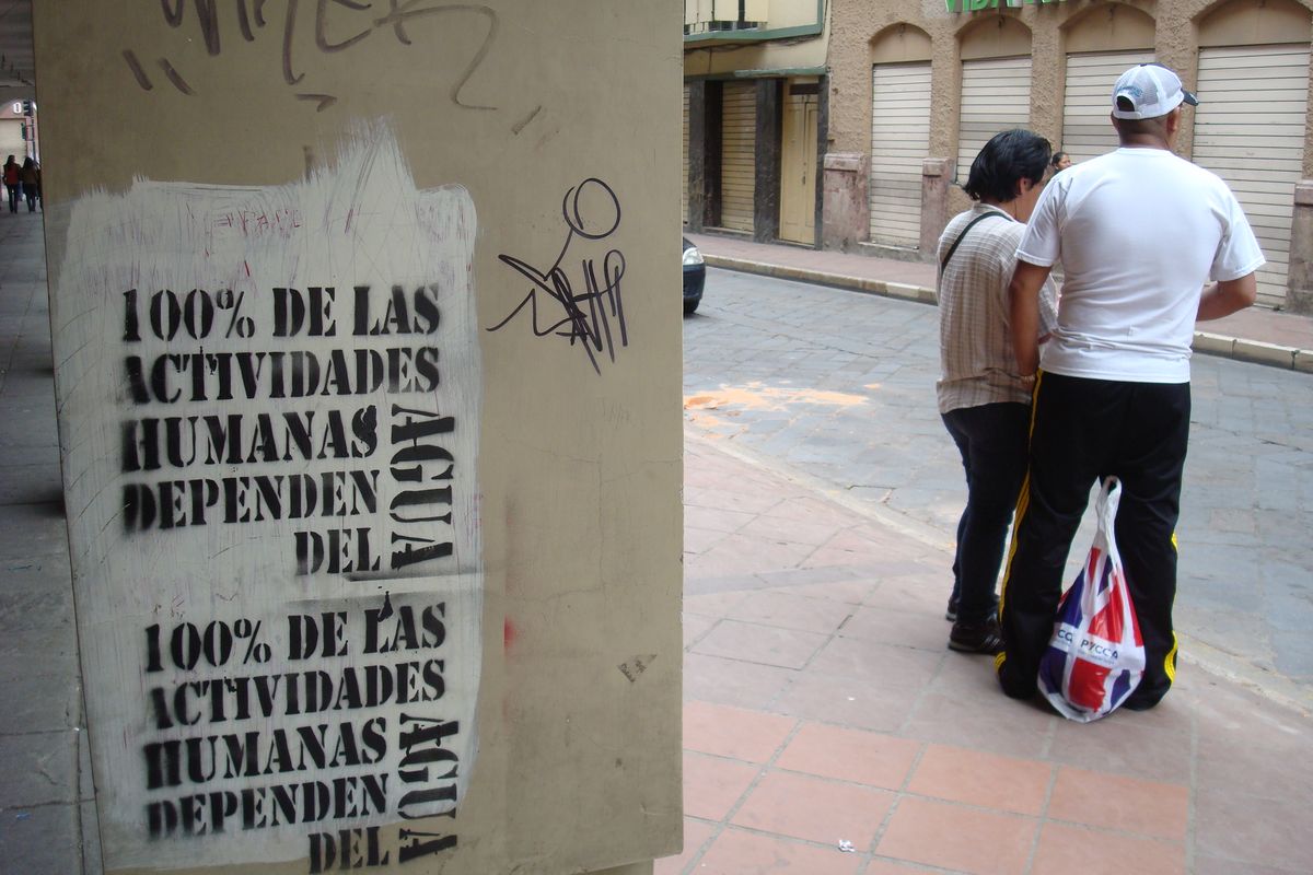 Loosely translated, all our activities depend on water -- this message is stenciled on many walls in Ecuador, but graffiti goes along with it.  (Shallan Knowles / Down to EarthNW Correspondent)