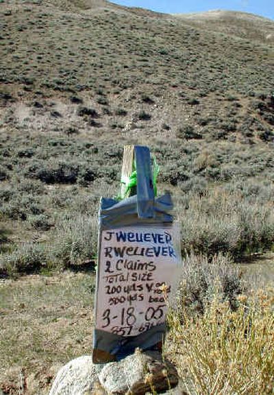
A wooden claim stake is one of many scattered on the barren landscape of Fremont County in south central Wyoming.
 (Associated Press / The Spokesman-Review)